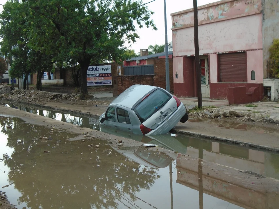 Por las intensas lluvias, un auto quedó atascado en una obra cloacal