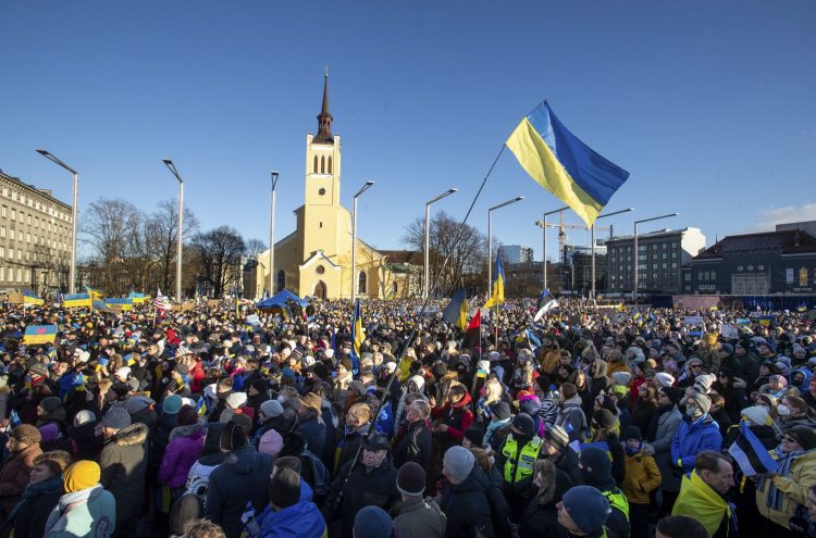 Demonstrators with Ukrainian and Estonian national flags gather for rally in support of Ukraine, in Tallinn, Estonia, Saturday, Feb. 26, 2022. Russian troops stormed toward Ukraine's capital Saturday, and street fighting broke out as city officials urged residents to take shelter. (AP Photo/Raul Mee)