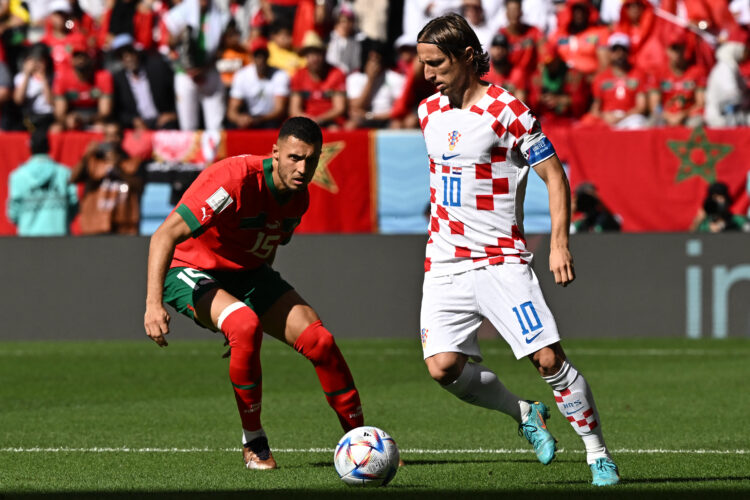 Croatia's midfielder #10 Luka Modric is challenged by Morocco's midfielder #15 Selim Amallah during the Qatar 2022 World Cup Group F football match between Morocco and Croatia at the Al-Bayt Stadium in Al Khor, north of Doha on November 23, 2022. (Photo by MANAN VATSYAYANA / AFP)