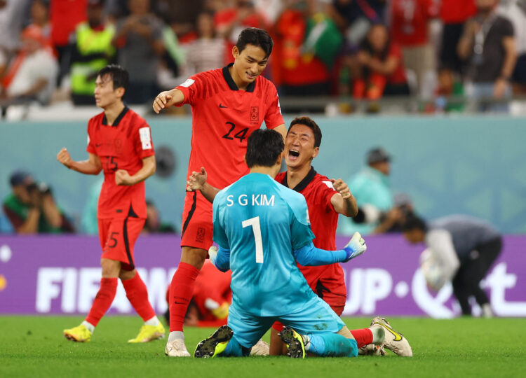 Soccer Football - FIFA World Cup Qatar 2022 - Group H - South Korea v Portugal - Education City Stadium, Al Rayyan, Qatar - December 2, 2022  South Korea's Kim Seung-gyu, Jung Woo-young and Cho Yu-min celebrate after the match as South Korea qualify for the knockout stages REUTERS/Matthew Childs