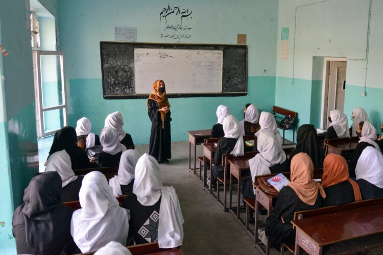 (FILES) In this file photo taken on March 23, 2022, Girls attend a class after their school reopened in Kabul. - The US has cancelled planned talks in Doha with the Taliban after the hardline Islamist rulers of Afghanistan shut girls secondary schools on March 23, 2022, US officials said. "We have cancelled some of our engagements, including planned meetings in Doha around the Doha Forum, and made clear that we see this decision as a potential turning point in our engagement," a State Department spokesperson said. (Photo by Ahmad SAHEL ARMAN / AFP)