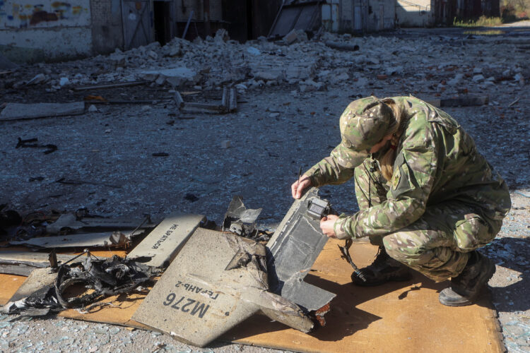 A police officer inspects parts of an unmanned aerial vehicle (UAV), what Ukrainian authorities consider to be an Iranian made suicide drone Shahed-136, at a site of a Russian strike on fuel storage facilities, amid Russia's attack on Ukraine, in Kharkiv, Ukraine October 6, 2022.  REUTERS/Vyacheslav Madiyevskyy