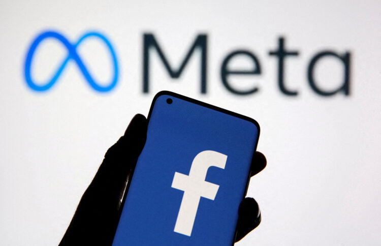FILE PHOTO: A smartphone with Facebook's logo is seen in front of displayed Facebook's new rebrand logo Meta in this illustration taken October 28, 2021. REUTERS/Dado Ruvic/Illustration/File Photo