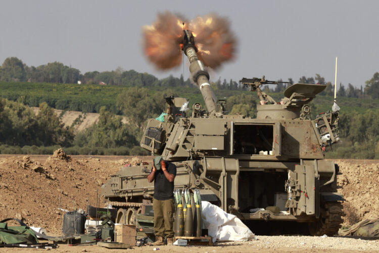 An Israeli army self-propelled artillery howitzer fires rounds from a position near the border with the Gaza Strip in southern Israel on December 7, 2023 amid battles between Israel and the Palestinian group Hamas in the Gaza Strip. (Photo by Menahem Kahana / AFP)